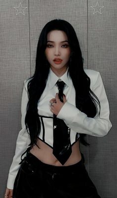 a woman with long black hair wearing a white shirt and tie posing for the camera