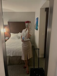 a woman taking a selfie in a hotel room