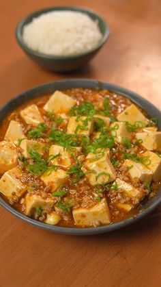 tofu and rice in a bowl on a wooden table