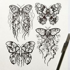 three butterflies drawn in black and white ink on paper with a pen next to it