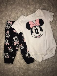 two baby minnie mouse onesuits are laying on the floor next to each other