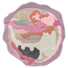 a circular rug with an image of a woman's face in pink and grey