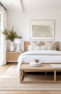 a bedroom with white walls and wooden furniture, including a large bed in the center