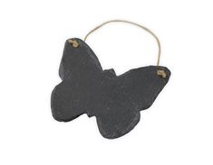 a black butterfly ornament hanging from a string