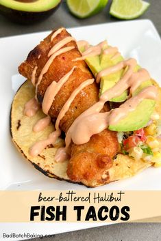 fish tacos on a white plate with avocado