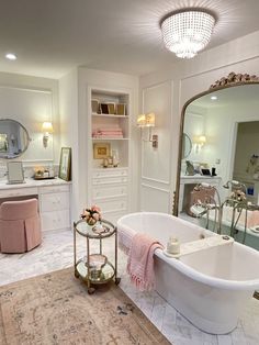 a white bath tub sitting inside of a bathroom