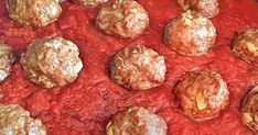 meatballs and sauce are cooking in a pan on the stove, ready to be cooked