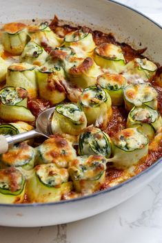 a casserole dish with zucchini and cheese