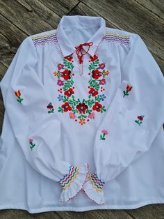 Traditional Hungarian Matyó floral handembroidered blouse . This blouse is new. Peasant blouse, colorful peasant blouse, embroidered blouse, floral blouse, ethnic embroidered blouse Beautiful wide shape boho, hippie, folk blouse with floral embroidered pattern.  Handmade blouse  Length: 24"  inch Bust : 48 - 49    ", Hand wash only. If you are buying several pieces I can combine postage at the time of mailing. If you have any question please don't hesitate to contact me,    For vintage Hungarian Peasant Blouse With Multicolor Embroidery For Spring, Peasant Tops With Multicolor Embroidery For Spring, Peasant Top With Multicolor Embroidery For Spring, Peasant Style Multicolor Embroidered Top For Spring, Multicolor Embroidered Peasant Top For Spring, Handmade Folk Tops For Summer, Spring Multicolor Embroidered Peasant Top, Handmade Multicolor Tops For Spring, Fitted White Folk Peasant Top