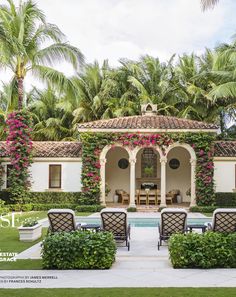 an outdoor dining area with chairs and tables next to a pool surrounded by palm trees