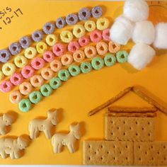 there are some cookies and other items on the yellow tablecloth that is decorated like a rainbow