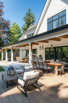 an outdoor living area with patio furniture and large windows on the side of the house