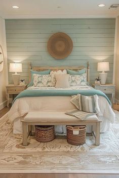 a bedroom with a large bed and two baskets on the floor