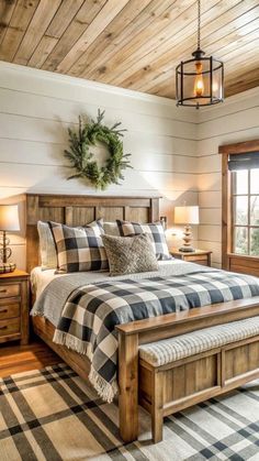 a large bed sitting in a bedroom next to a wooden dresser and window with a wreath on top of it