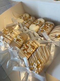 a box filled with cookies covered in white and gold decorations