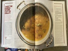 an open magazine with a bowl of soup in it