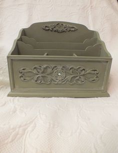 a green box with ornate designs on it