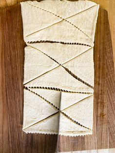 several pieces of bread wrapped in twine on a cutting board with string attached to them