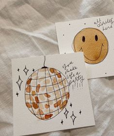 two greeting cards with an image of a smiley face on one and a happy smile on the other