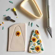 some crafting supplies are laying out on a white table with scissors and other items