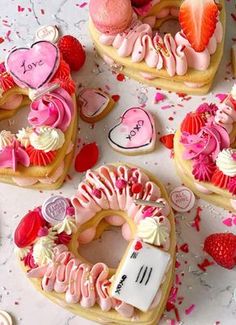 valentine's day decorated cookies and pastries on a table