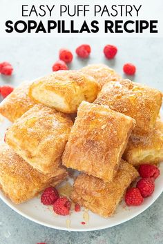 some raspberries on a white plate with sugar