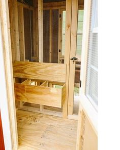 the inside of a chicken coop with its doors open