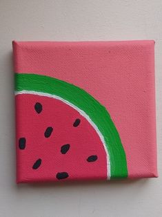 a painting of a watermelon slice on a white wall