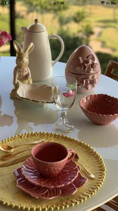 a table with plates, cups and utensils sitting on top of each other