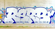 graffiti on the side of a building with blue and white letters that read rad