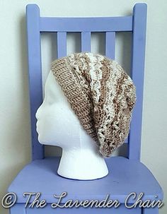 a knitted hat sitting on top of a blue chair next to a white head