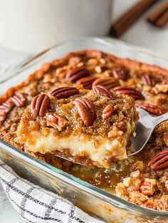 a glass casserole dish filled with pecan pie and topped with a spoon