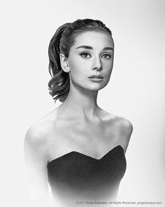 a black and white photo of a woman in a strapless dress with her hair pulled back