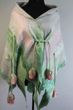 a green and pink shawl on a mannequin's head with flowers