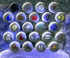 a bunch of different types of buttons sitting on top of a rock