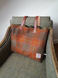 Beautifully handcrafted Harris Tweed bag with real leather handles secured with brass rivets.  Burnt orange Harris Tweed with green and yellow overcheck on both sides.  Real leather straps measuring 32  inches.   Fully lined with dark green velvet. Measures approximately 17 by 14 inches.  Harris Tweed Orb label has been sewn on the back of the bag. Harris Tweed Bag, Wool Tote Bag, Tweed Handbag, Wool Tote, Dark Green Velvet, Tweed Bag, Embroidered Cushions, Harris Tweed, Green And Yellow