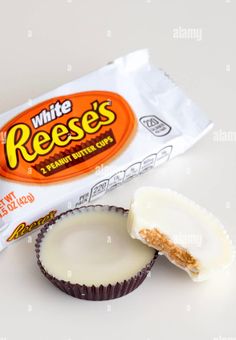 reese's peanut butter cupcakes with the wrapper open on a white background - stock image