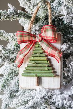 a christmas tree ornament made out of wooden sticks