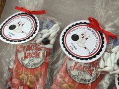 three bags of jack and jones candies wrapped in cellophane with red ribbon