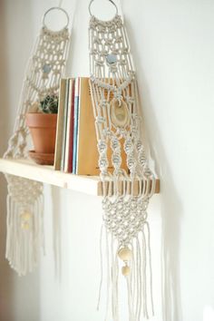 the hanging wall shelf is made from macrame and has bookshelves on it