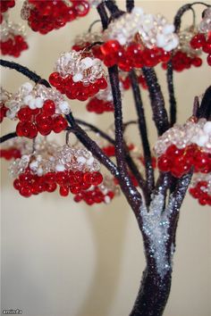 a red and white beaded tree is shown