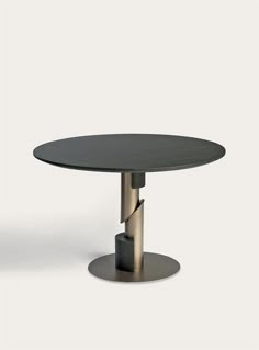 an oval table with two metal legs and a black top, in front of a white background