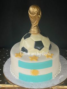 a cake decorated with a soccer ball and stars on the top is sitting on a table