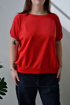 Sixties/Seventies Red Sweatshirt Tee. Raglan Sleeve. Ribbed Collar, Cuff & Hem. No Content Label No Size Tag Excellent Vintage Condition - Small Hole in Back. All Measurements Taken Flat Chest-23.5" Shoulder to Hem-23.5" All Sales Are Final. We have taken the time to note all size measurements and the condition of each piece so please look over all the information of the garment you are considering purchasing. Please note that all items are sold in "Vintage Condition". If you have any further qu Red Retro Relaxed Fit Tops, Retro Crew Neck Solid Tops, Red Sweatshirt, Vintage Short, Vintage Shorts, Flat Chest, Raglan Sleeve, Sweat Shirt, Bathing Beauties