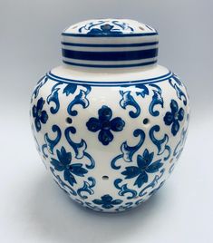 a blue and white vase sitting on top of a table