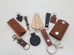 leather key fobs are laid out on a white surface