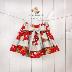 a red and white dress hanging on a clothes line with the words sew simple & pretty