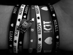 the bracelets are decorated with different types of hearts and words on them, all in black and white