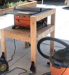 a table that has some tools on top of it and a vacuum in the background