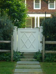 a white gate in front of a house